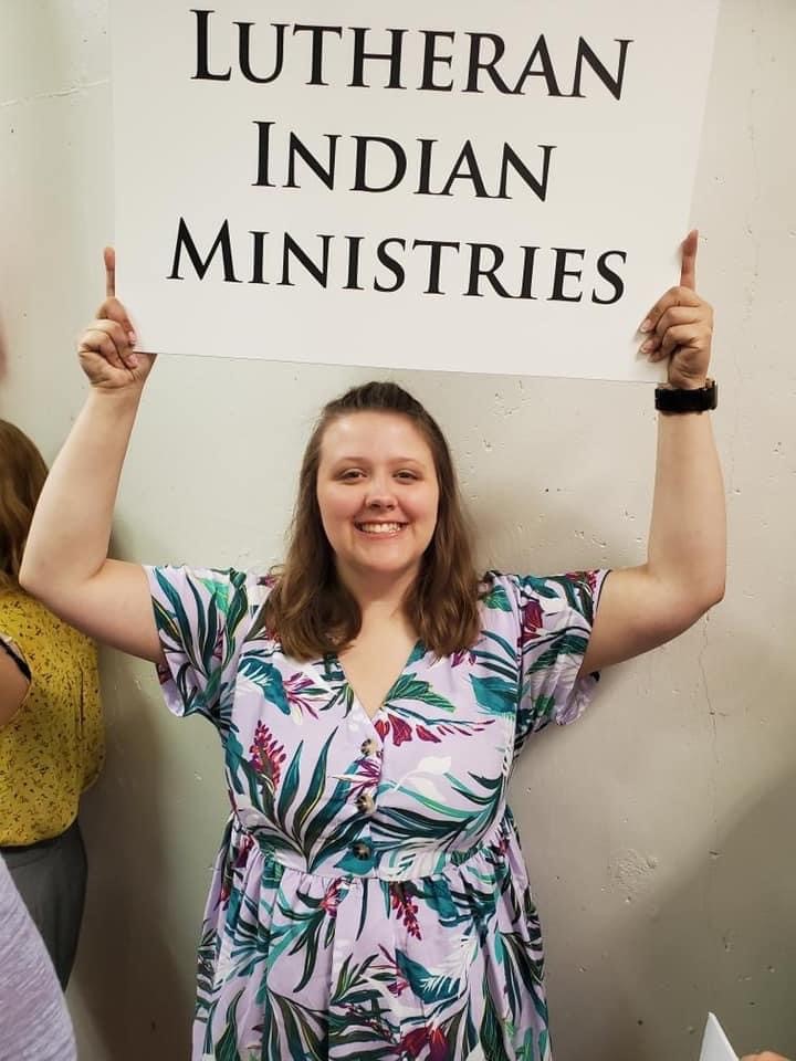 LWML NID Young Woman Representative holding up the Lutheran Indian Ministry sign for the 2021 LWML Convention procession